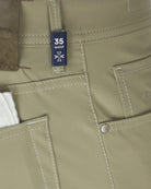 Light taupe chino pocket seam detail with size label and front pocket stitching