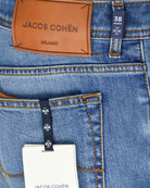 Men's stretch denim jeans detail: JACOB COHEN MILANO label, 38 waist tag, stitching