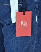 Denim jeans fabric detail with Tramarossa red hang tag