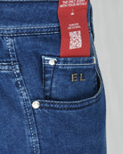 Blue denim jeans coin pocket with EL metal rivets and small brand tag