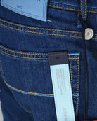 Dark blue denim jeans coin pocket button and yellow contrast stitching with inner label