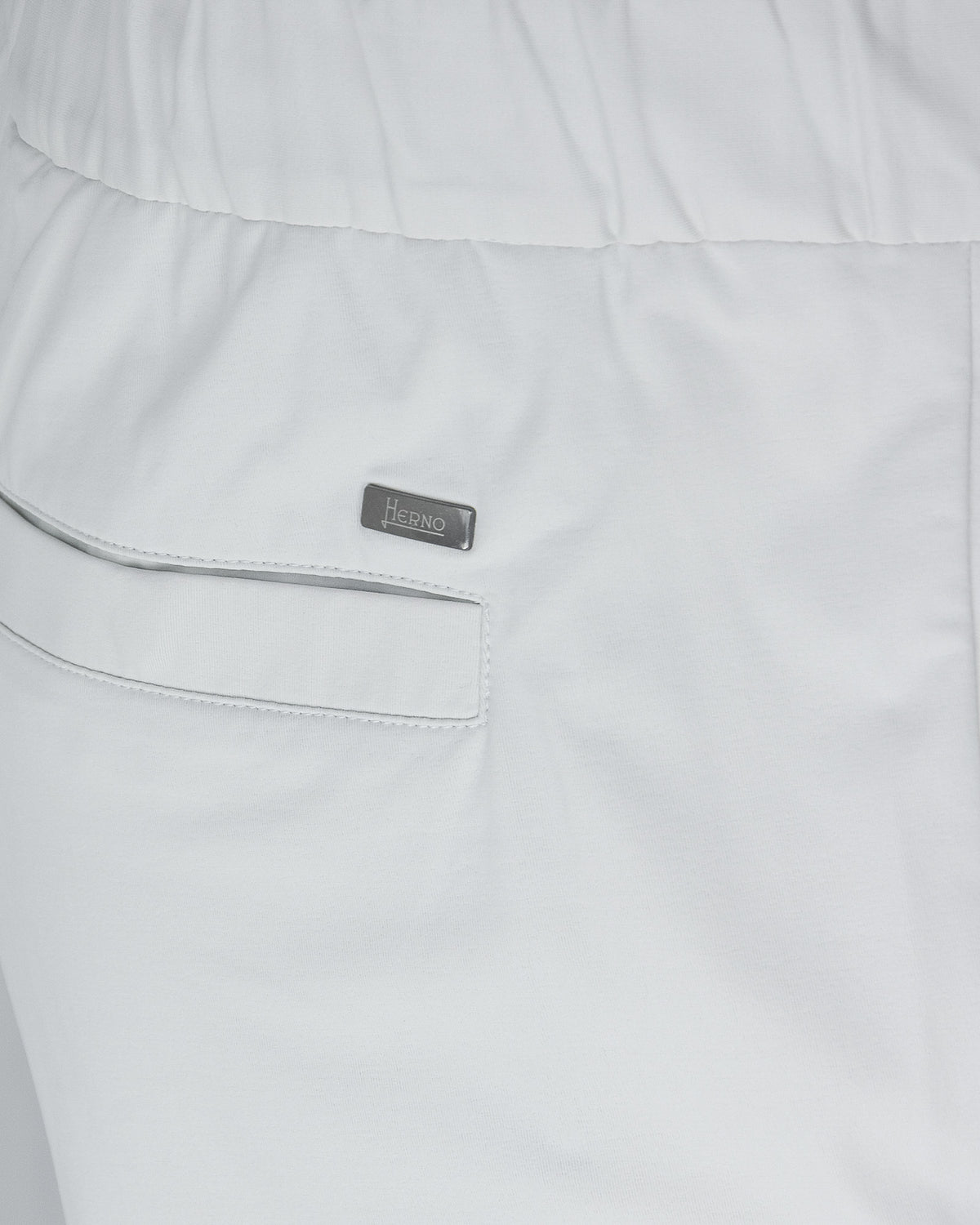 Off-white pants close-up: side pocket with welt seam and Herno label