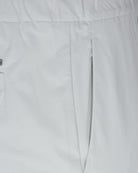 Off-white pants close-up: front dart seam and center seam, smooth jersey fabric