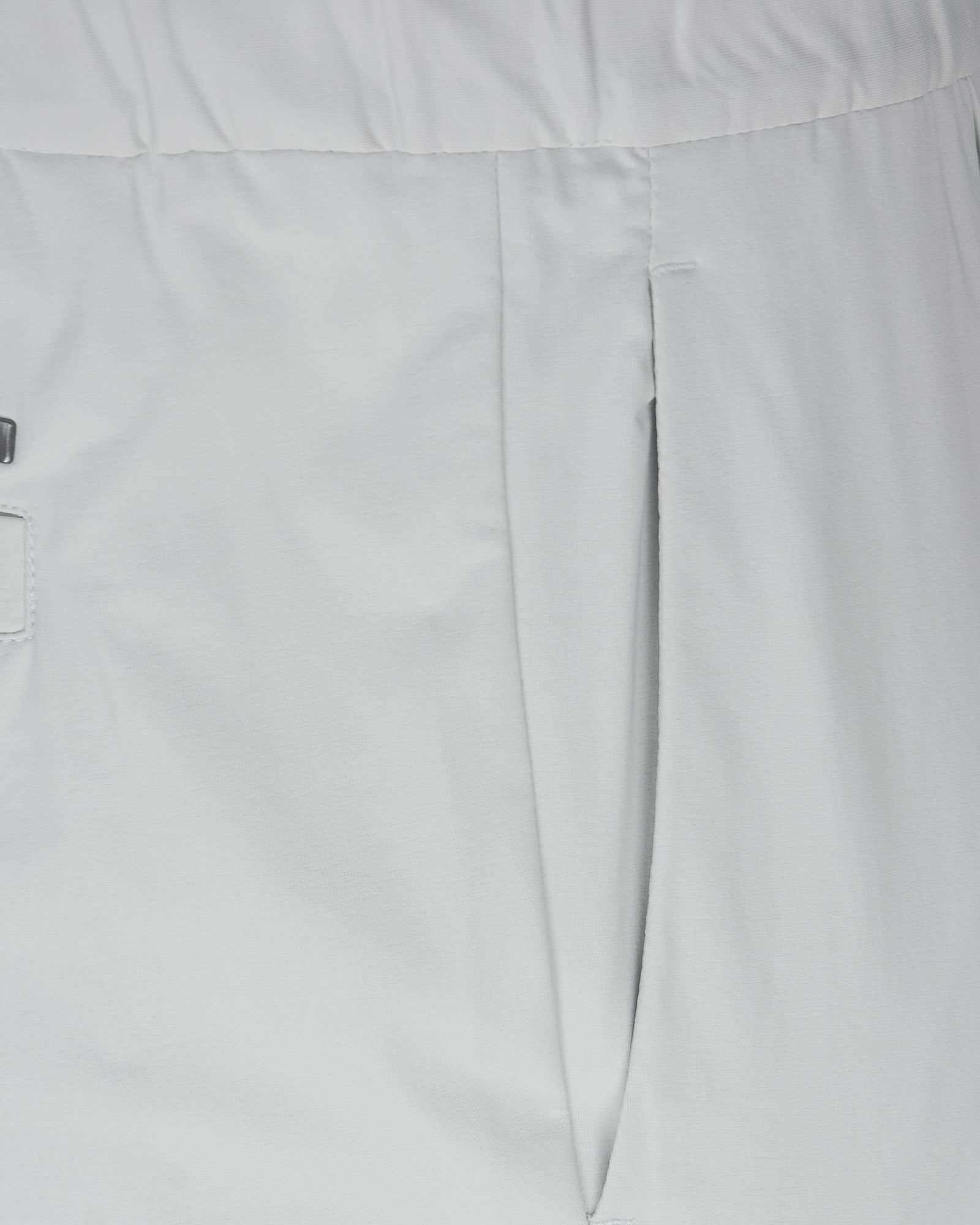 Off-white pants close-up: front dart seam and center seam, smooth jersey fabric