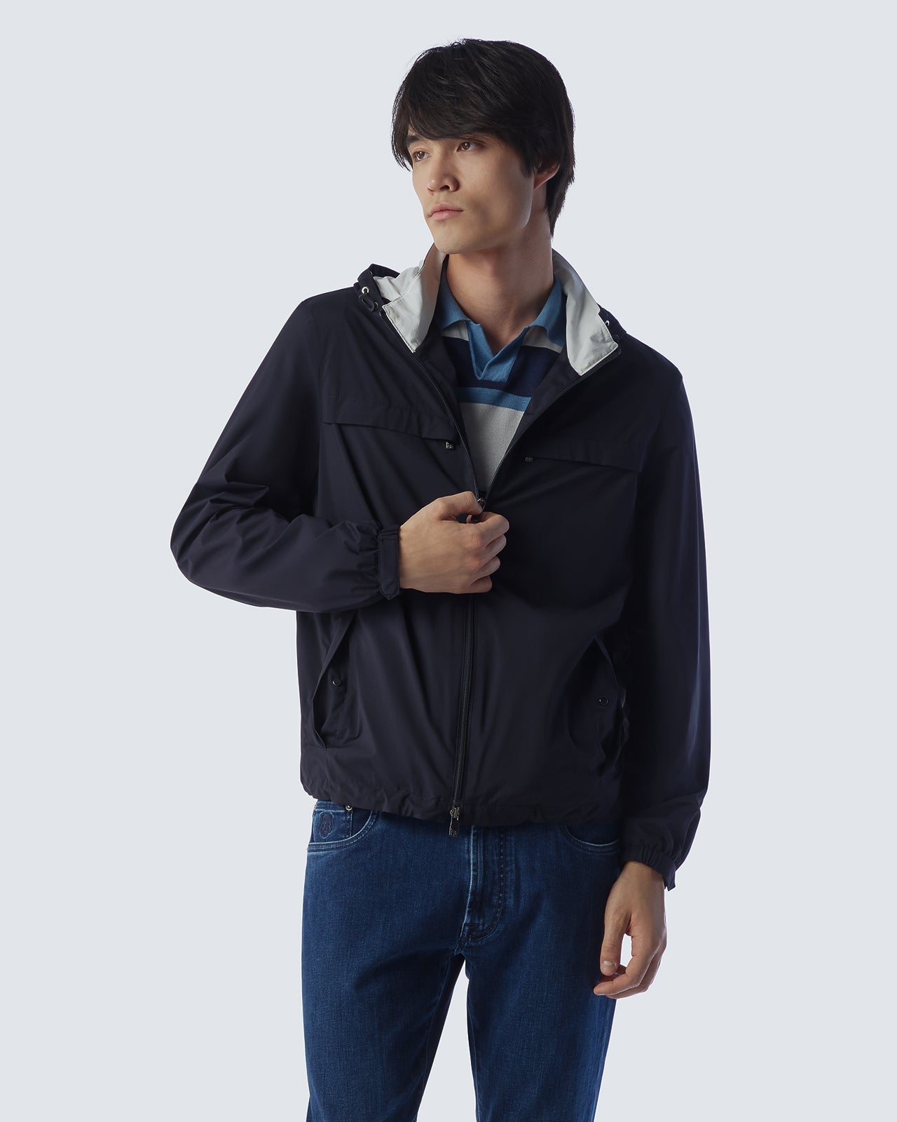 Navy hooded jacket worn over a blue shirt, full front zip and drawcord