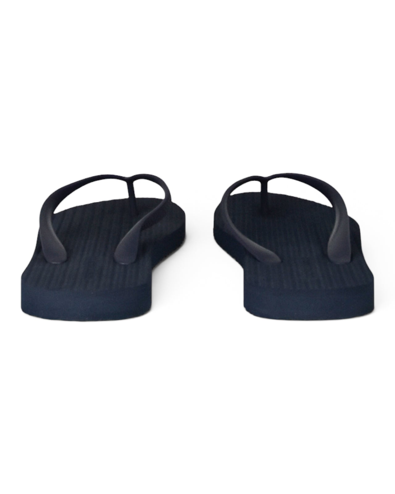 Two dark blue flip-flops showing the underside and toe-post