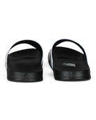 Black pool sliders from above showing thick footbed and wide strap