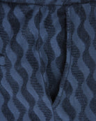Blue jacquard terry fabric close-up with dark irregular wave pattern