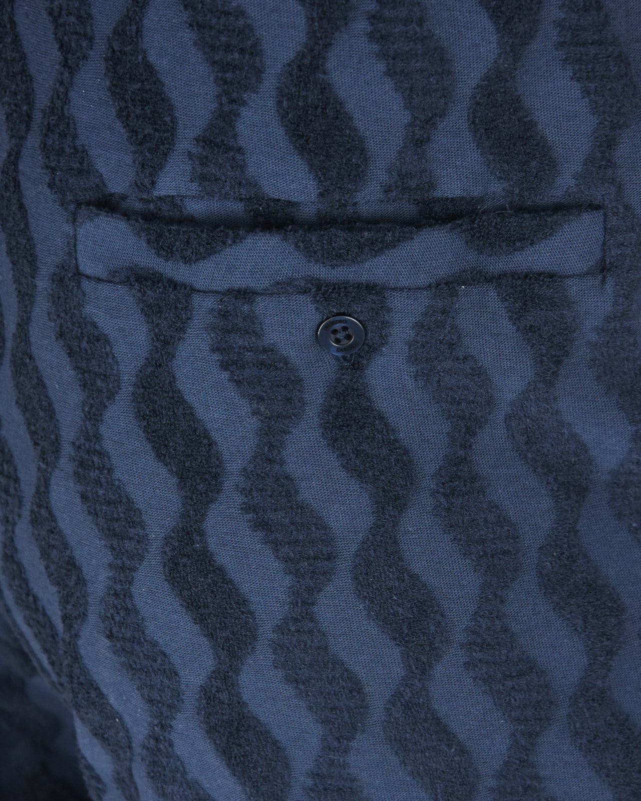 Blue jacquard terry shorts close-up of front button and waistband