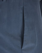 Navy silk-stretch pants fabric close-up with side seam and smooth finish