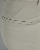 Beige silk stretch pants detail: tapered waistband seam and front pocket