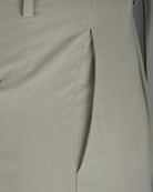 Beige silk stretch pants detail: front fly seam and stitched panel