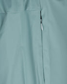 Teal blue shorts close-up of side seam and zipper pull detail.