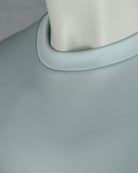Crew neck trim close-up on light sky blue T-shirt
