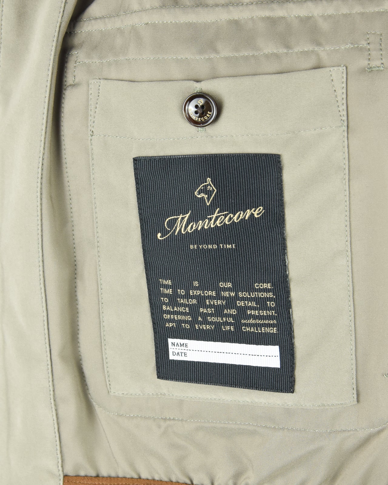 Smoke green blouson jacket interior care label with Montecore logo