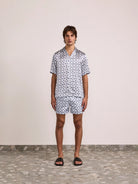 Men's short sleeve shirt with repeating spiral print and open collar