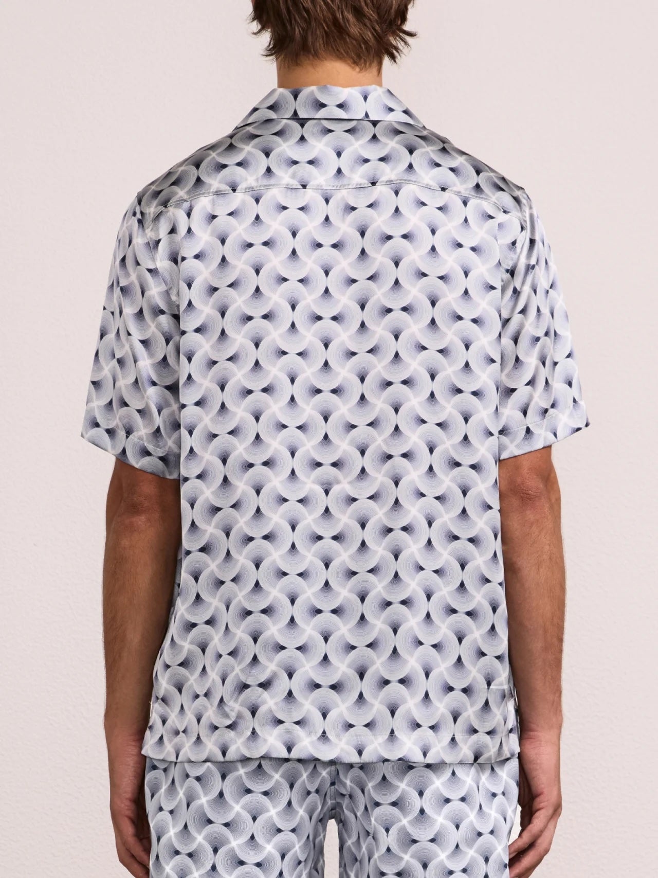 Back view of men's short sleeve silk shirt with repeating spiral print