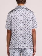 Back view of men's short sleeve silk shirt with repeating spiral print
