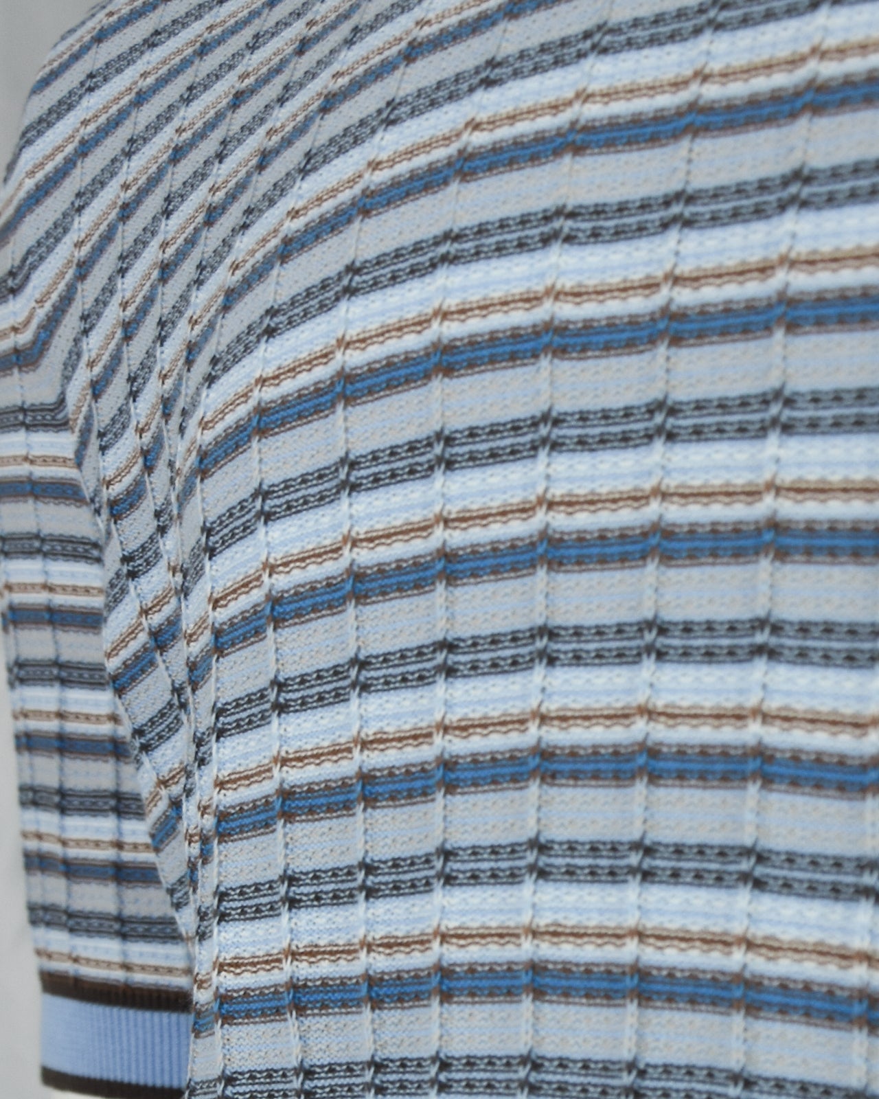 Blue, tan, and dark striped knit polo fabric detail with textured horizontal lines