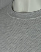 Grey textured knit T-shirt close-up of ribbed crew neckline