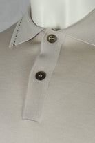 Stone beige polo collar with two dark buttons and contrast-stitched placket