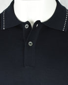 Navy polo collar with two-button placket and contrast stitch detail at yoke