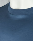 Deep blue high neckline ribbed collar on a short sleeve t-shirt, close-up.