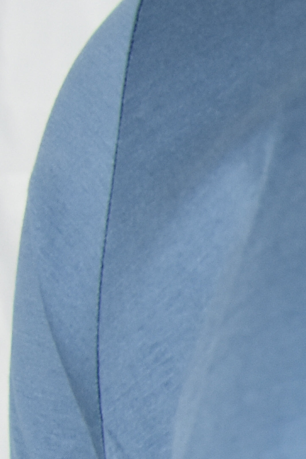 Deep blue short sleeve t-shirt fabric close-up with side seam detail.