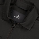 Soft wool shirt jacket detail: WAHTS label and metal zip on dark placket