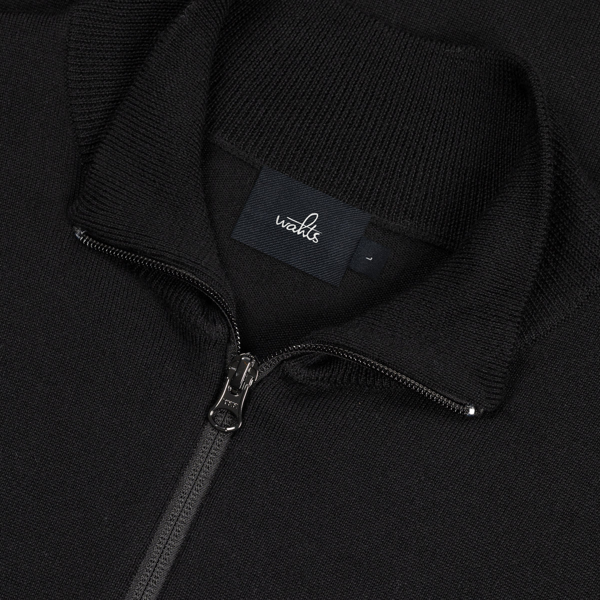 Pure black merino half-zip pullover close-up of zipper and WAHTS neck label