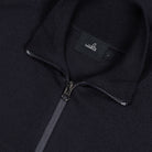 Dark blue merino half-zip pullover detail: metal zipper and brand neck label