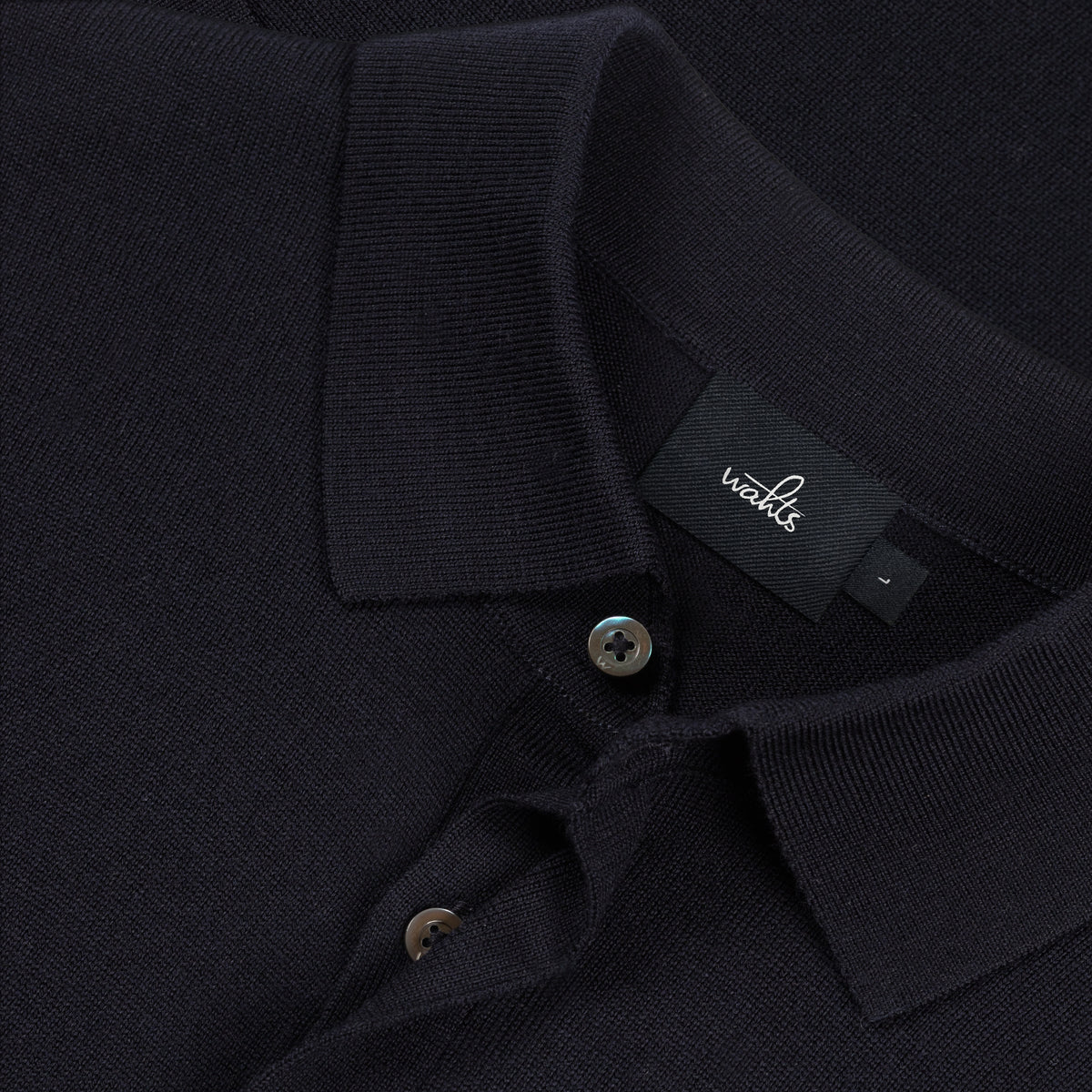 WAHTS polo shirt collar detail with button placket and woven brand tag