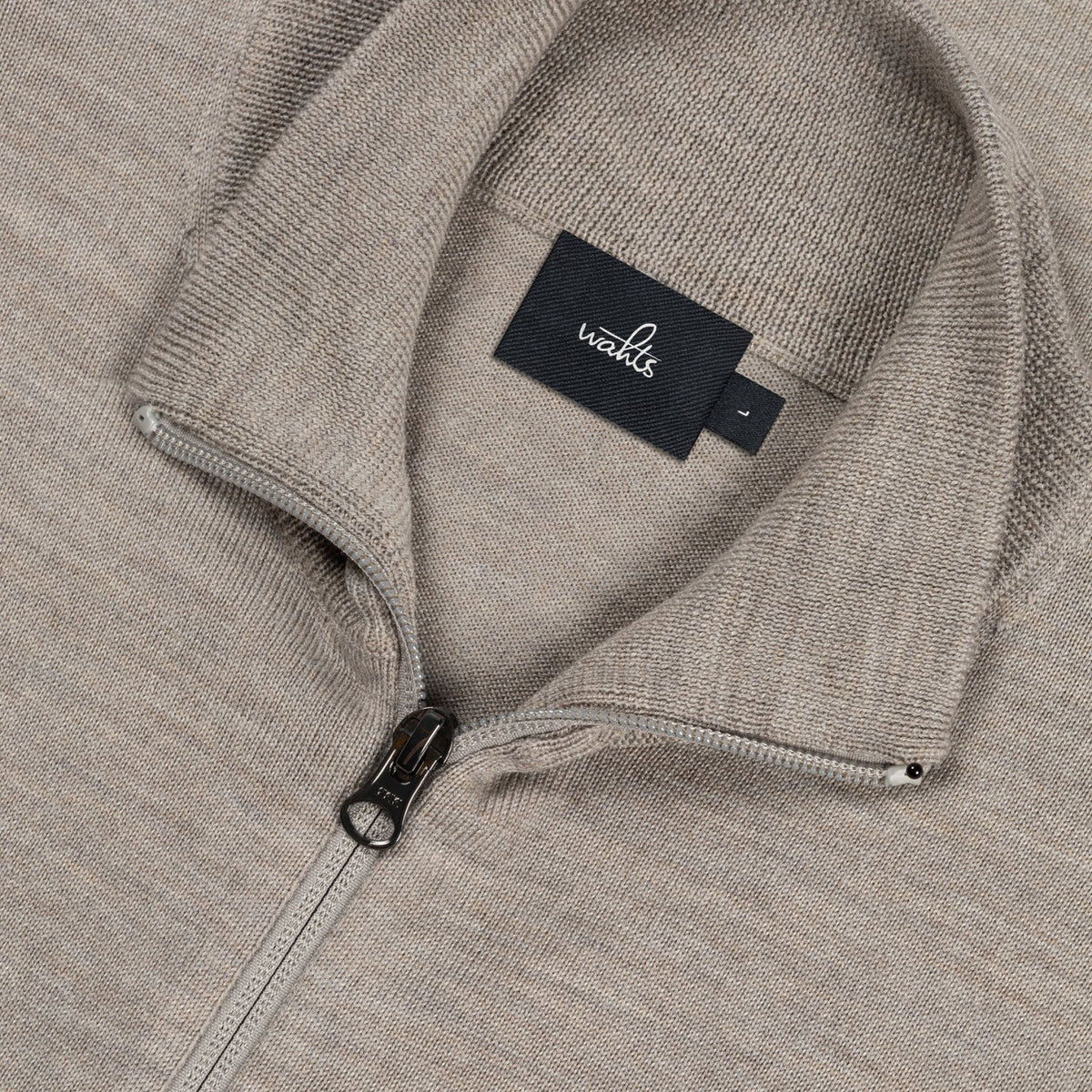 WAHTS taupe merino cardigan close-up showing stand collar, zipper, and neck label