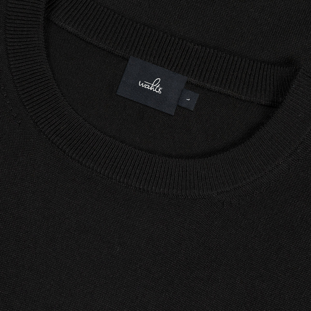 WAHTS crewneck neckline detail with inner neck label, pure black