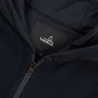 WAHTS hood label and zipper close-up on night blue hoodie