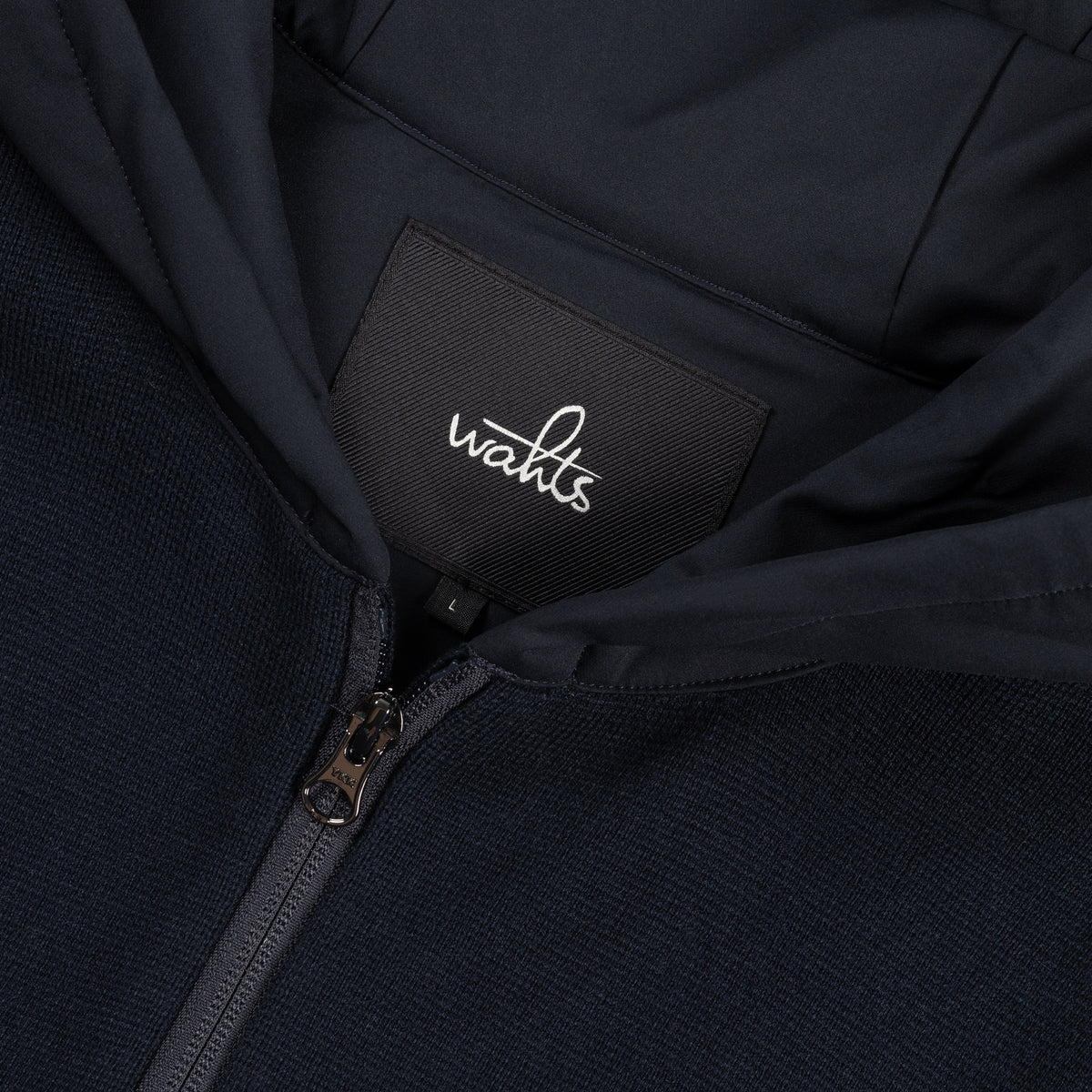 WAHTS hood label and zipper close-up on night blue hoodie