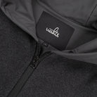 WAHTS logo label and front zipper detail on dark hoodie