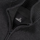 Black WAHTS logo patch on dark full-zip cardigan neck zipper detail