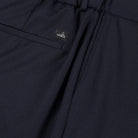 Deep navy soft wool trouser detail with stitched logo patch