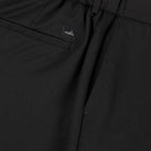 Soft wool travel trousers detail: WAHTS logo label and fabric fold