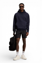 Black above-knee shorts with elastic waistband and side pockets
