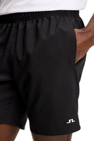 Black shorts with elastic waistband and small white JL logo at hem