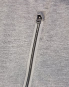 Reversible bomber jacket close-up of heather gray front with metal zipper and pull tab