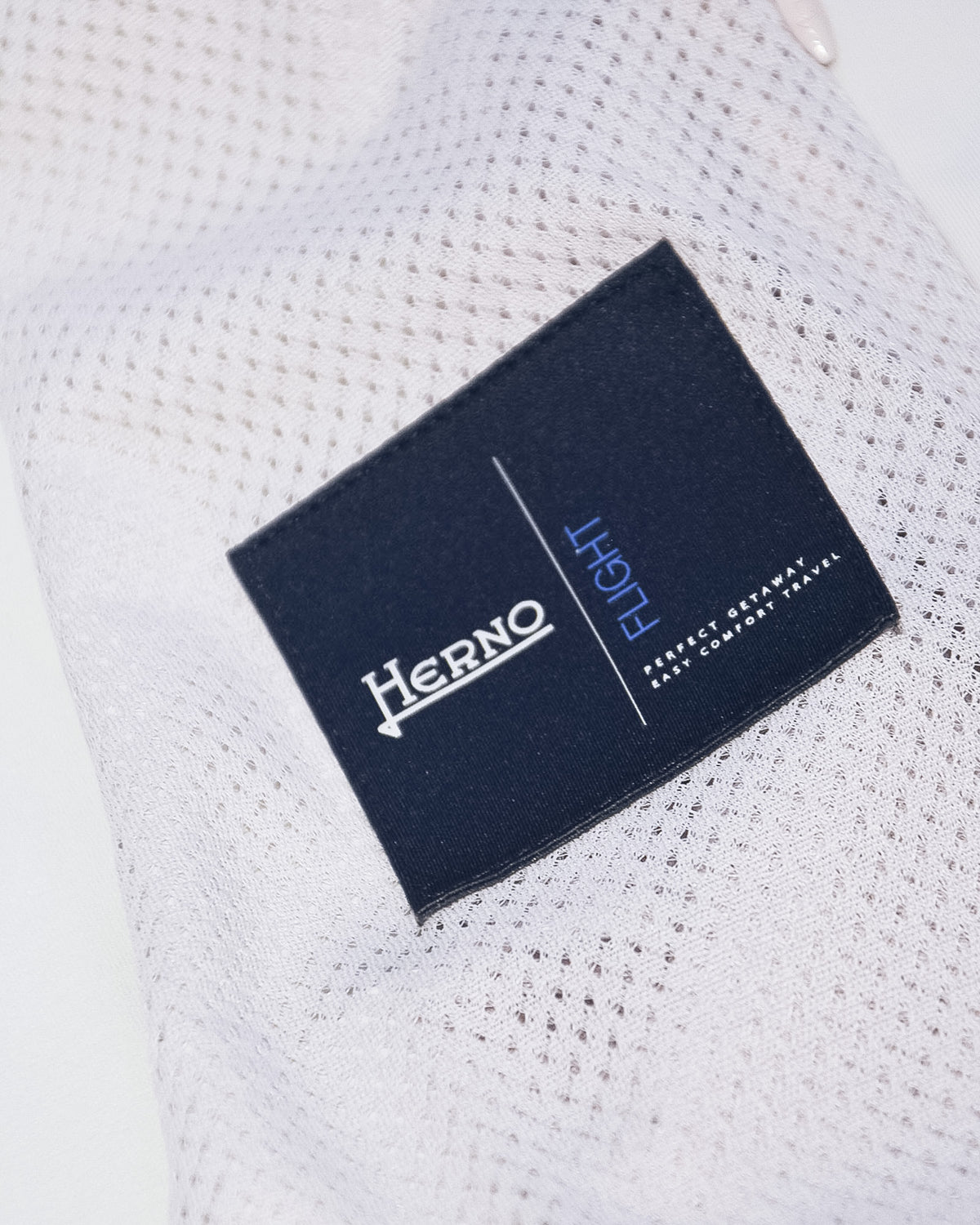 Herno nylon jacket interior neck label on off-white textured fabric