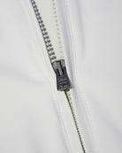 Off-white nylon jacket front zipper with dark pull and metal slider