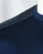 Navy blue T-shirt neckline and shoulder seam with textured trim