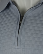 Light-blue polo with front zipper placket and check-textured knit