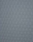 Light-blue textured knit fabric panel with raised square pattern
