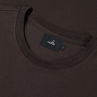 Deep brown jersey crew-neck T-shirt close-up of interior neck label