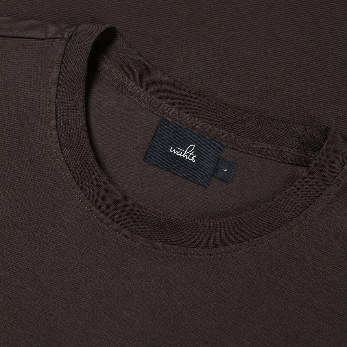 Deep brown jersey crew-neck T-shirt close-up of interior neck label